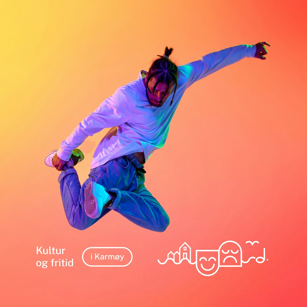 young guy dancer is dancing break in neon lighting, male acrobat is doing trick and dance exercise on red blue background, hip hop performer is moving and standing on his hands